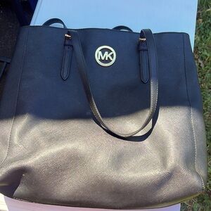 Black Micheal kors tote purse with gold emblem